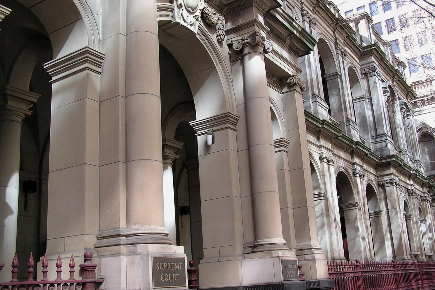 The Supreme Court of Victoria colonnade on William Street, Melbourne, with the Supreme Court plaque on the pier. The Court of Appeal decided Singh v Singh Homes Pty Ltd here.