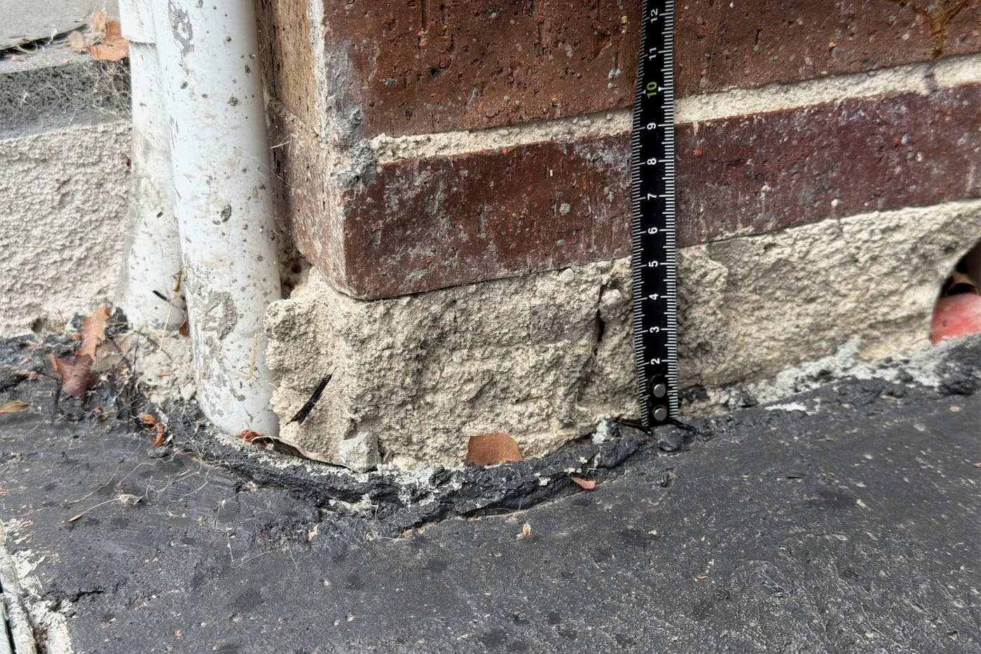 Stepped cracking through brickwork at a masonry pier