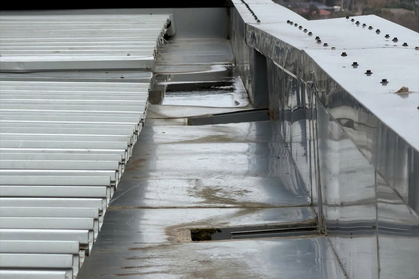 Water ponding across a low-pitch metal roof