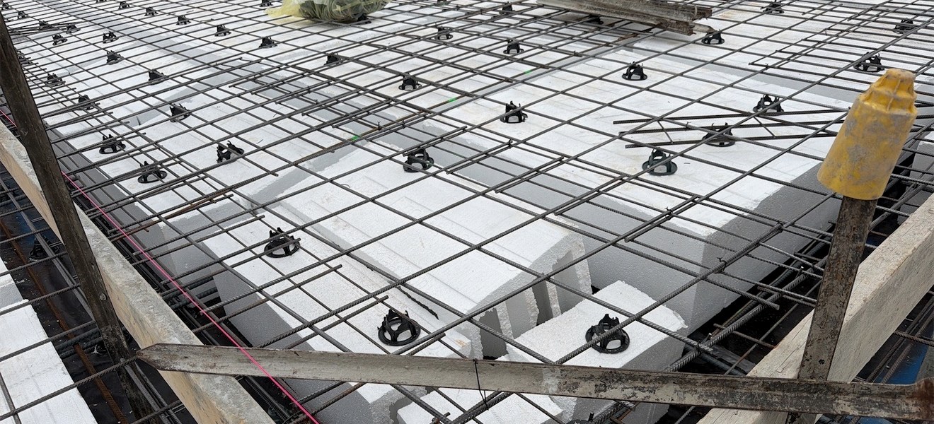 Reinforcing steel and formwork inspected on a residential building site before the concrete pour
