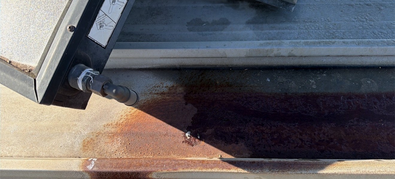 Corroded roof plumbing and failed flashing found during a roof inspection